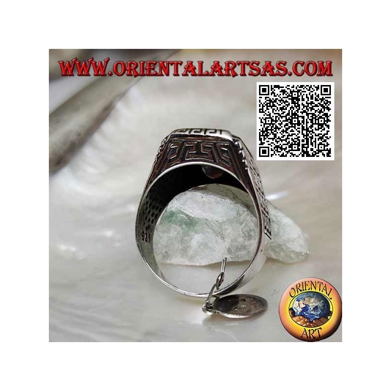 Silver ring with faceted rectangular garnet and geometric labyrinth engraved on the sides