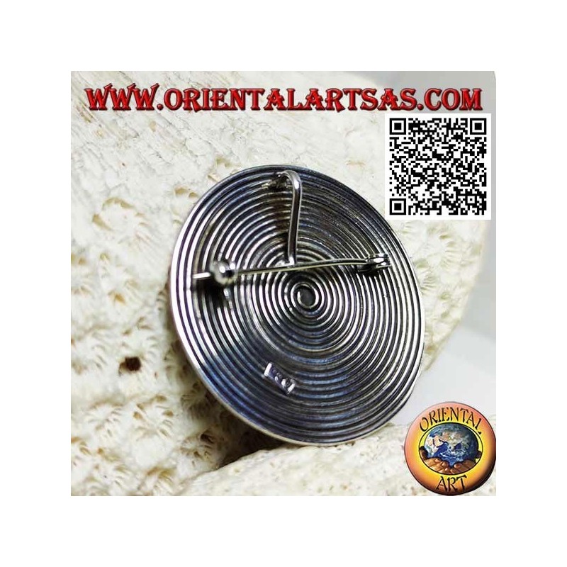 Round spiral silver brooch with central ball
