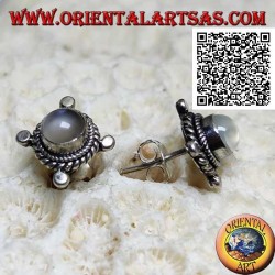 Silver earrings with round moonstone surrounded by interweaving and disks on the cardinal points