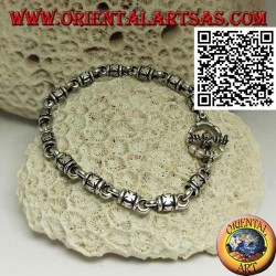 Soft silver cylinder bracelet with embossed maltese crosses alternating with rings and T-shaped clasp