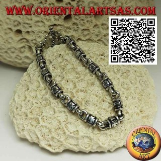 Soft silver cylinder bracelet with embossed maltese crosses alternating with rings and T-shaped clasp