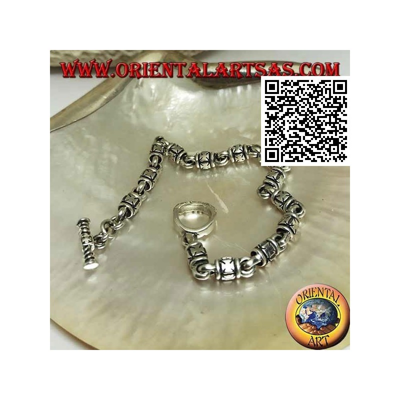 Soft silver cylinder bracelet with embossed maltese crosses alternating with rings and T-shaped clasp
