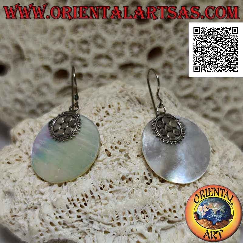 Silver earrings with flat round mother-of-pearl pendant attached to a six-petal flower