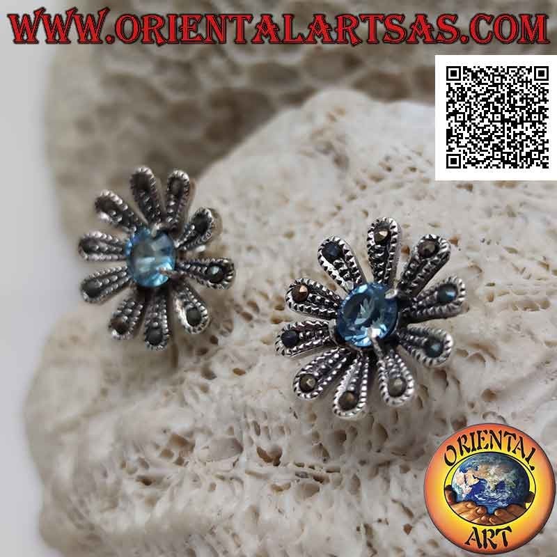 Silver lobe earrings in the shape of a large daisy studded with marcasite and central round blue topaz