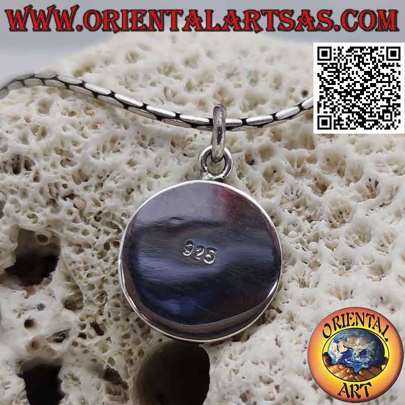 Round silver pendant with spiral on a black resin background