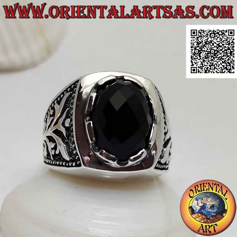 Silver ring with oval cabochon faceted onyx set and climbing plant in bas-relief on the sides