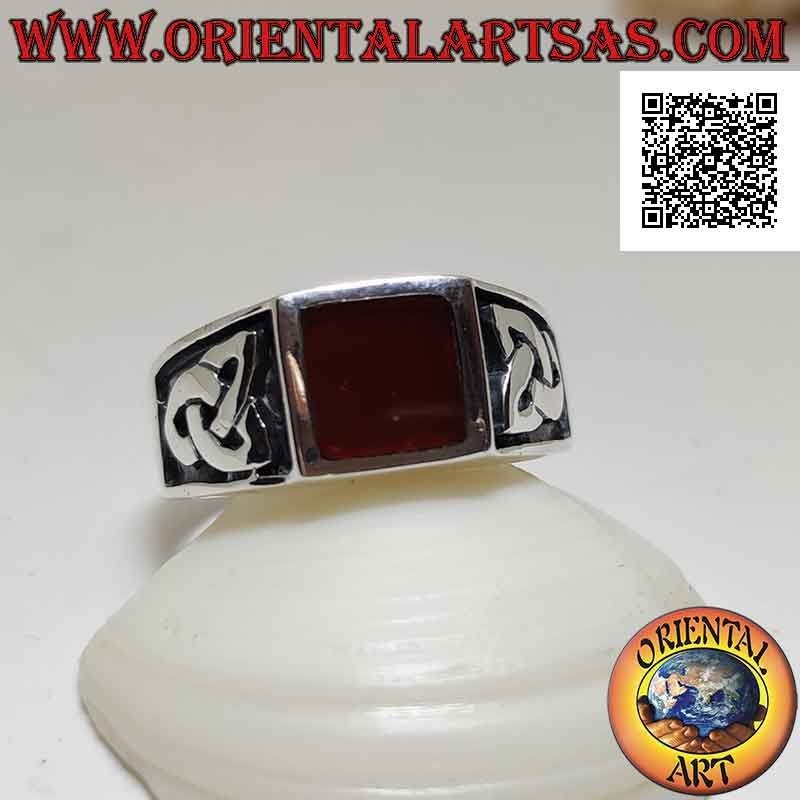 Silver ring with square carnelian flush with the edge and bas-relief triquetra on the sides