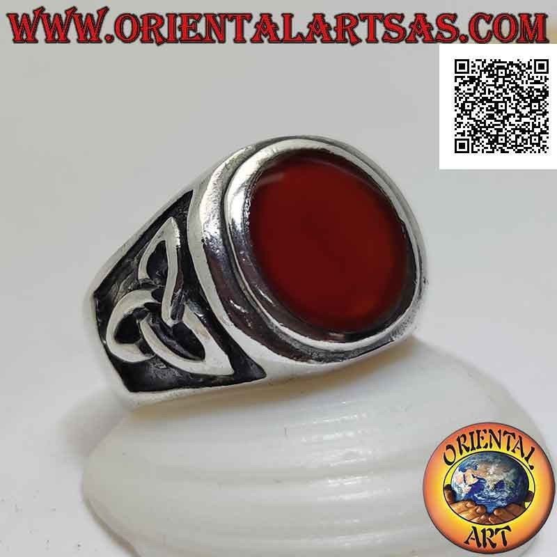 Silver ring with round carnelian flush with raised edge and bas-relief triquetra on the sides