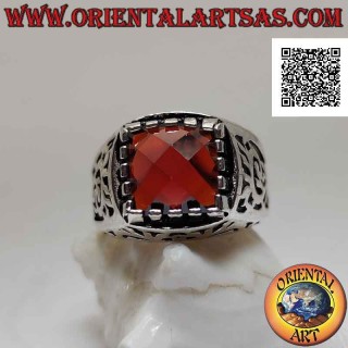 Silver ring with faceted garnet set in a square surrounded by openwork decoration