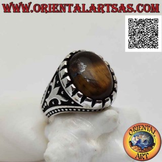 Silver ring with cabochon oval tiger eye and tree and balls in bas-relief on the sides