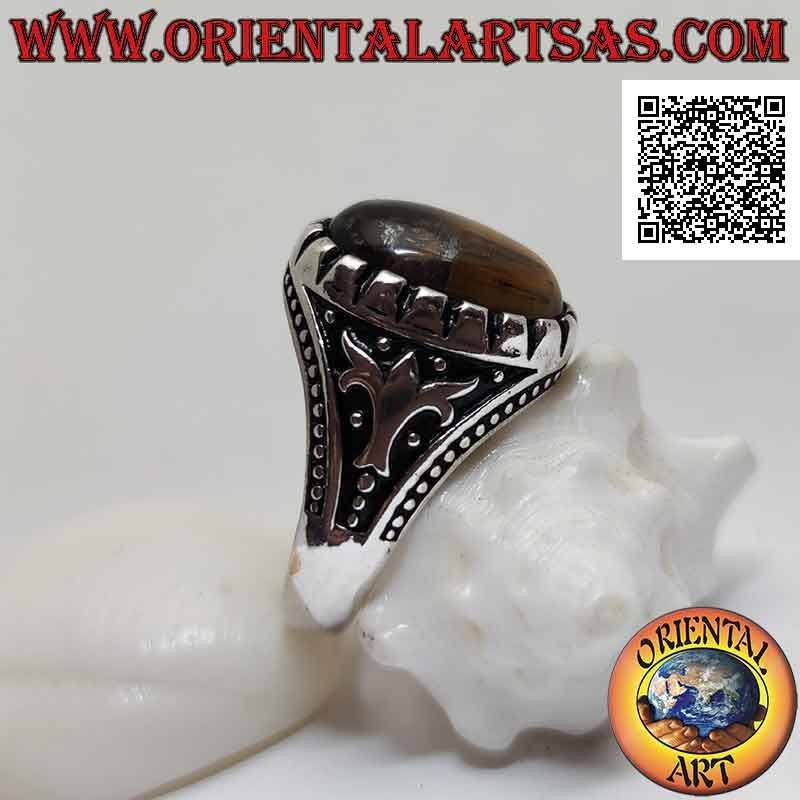 Silver ring with cabochon oval tiger eye and tree and balls in bas-relief on the sides