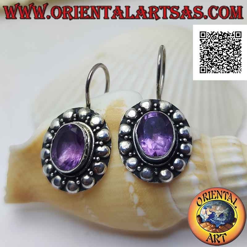 Silver leverback earrings with faceted oval amethyst surrounded by interweaving and studs