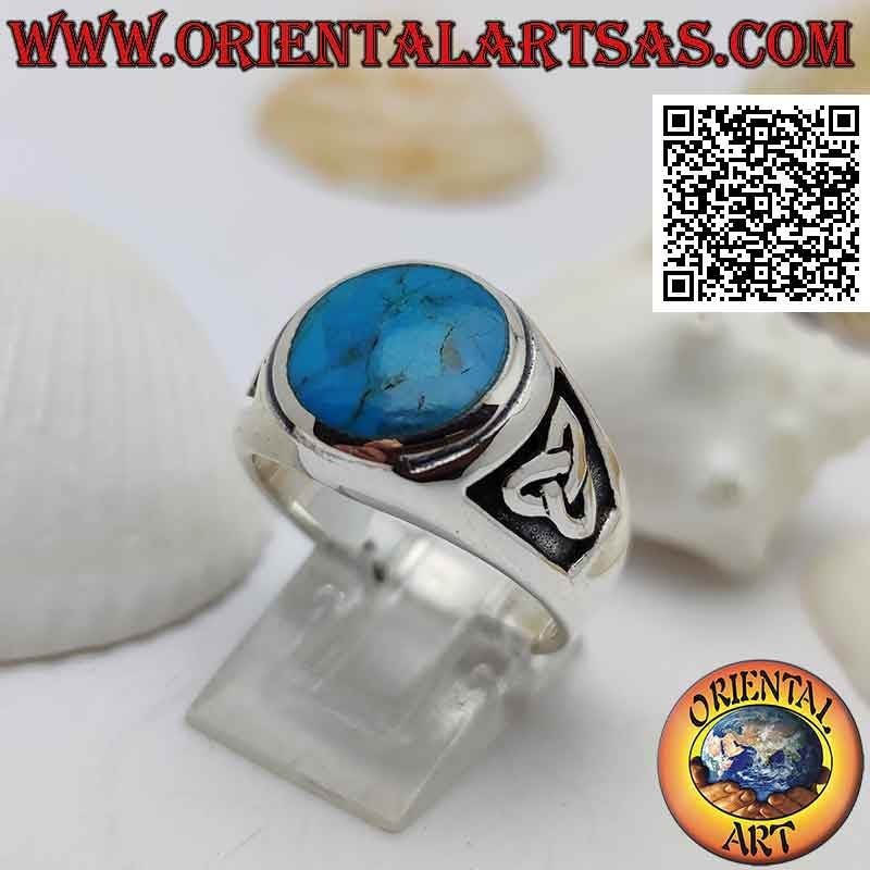 Silver ring with round turquoise flush with raised edge and bas-relief triquetra on the sides