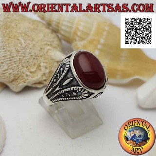 Silver ring with faceted oval carnelian and bas-relief oxidized grotesque decoration