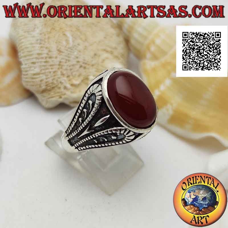 Silver ring with faceted oval carnelian and bas-relief oxidized grotesque decoration