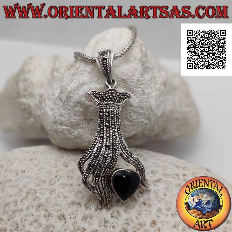 Silver pendant, onyx heart between the fingers of a hand studded with marcasite