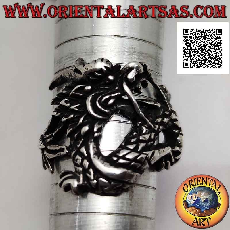 Silver ring in the shape of an oriental dragon with a mustache in motion and an enveloping tail