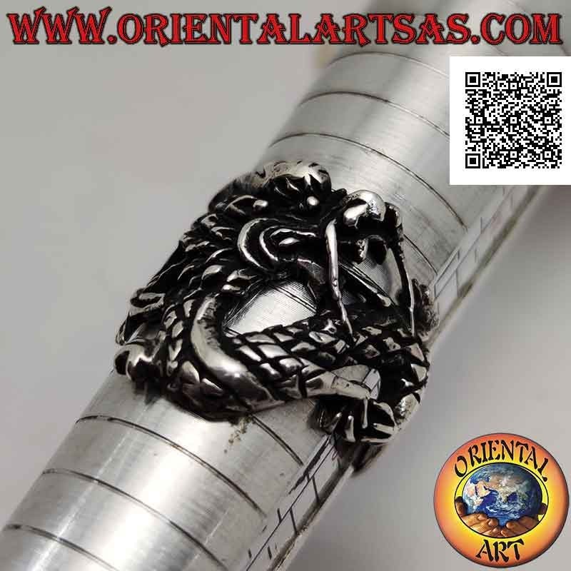 Silver ring in the shape of an oriental dragon with a mustache in motion and an enveloping tail