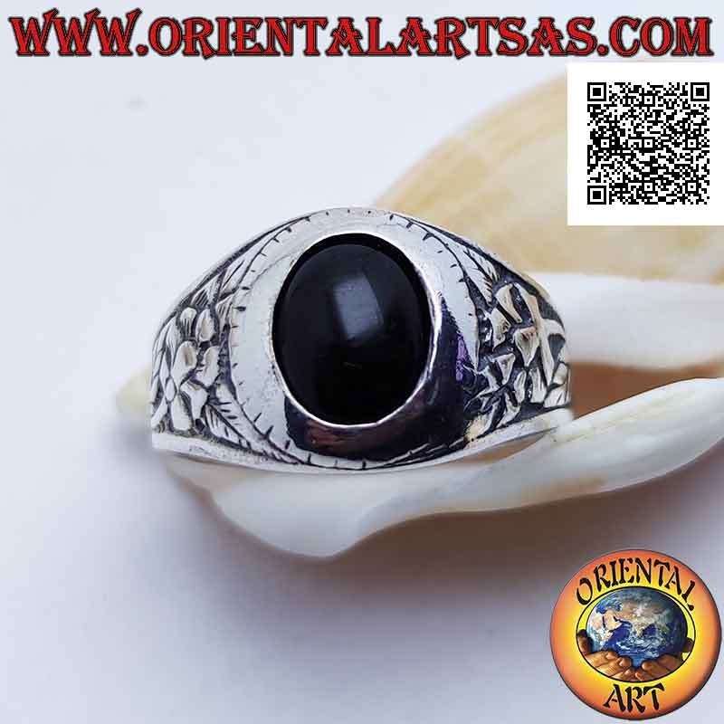Silver ring with oval cabochon onyx and flower of rebirth in bas-relief on the sides