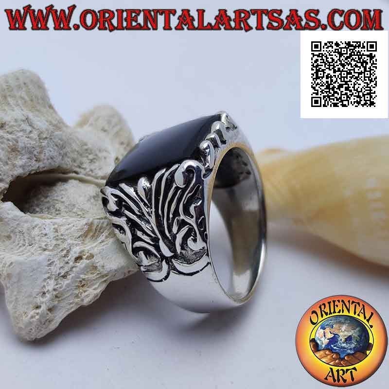 Silver ring with square onyx surrounded by baroque engravings on an imposing setting