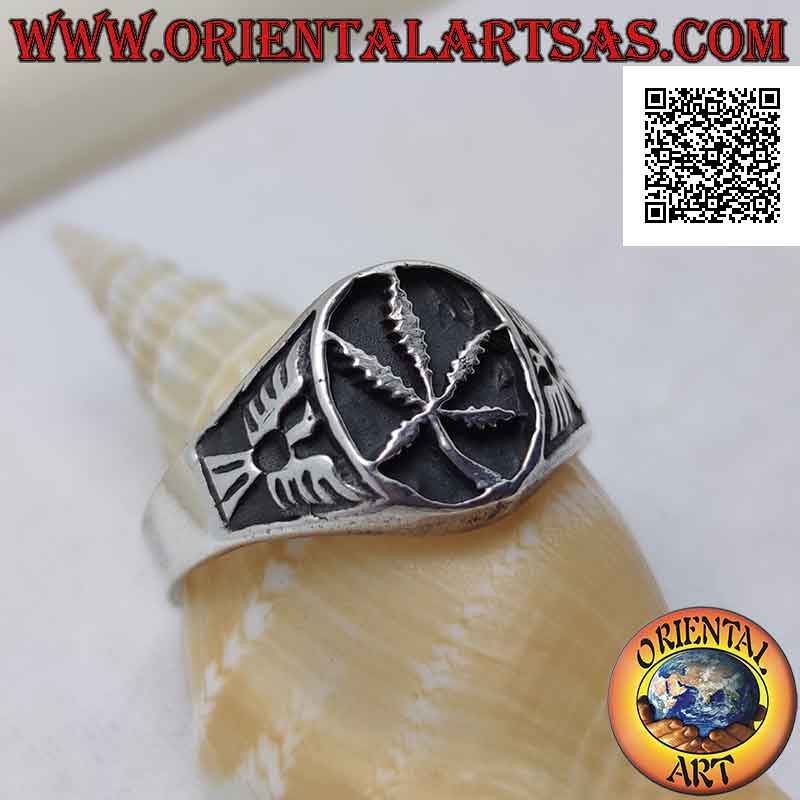 Silver ring with marijuana leaf in the oval in bas-relief and eagle on the sides