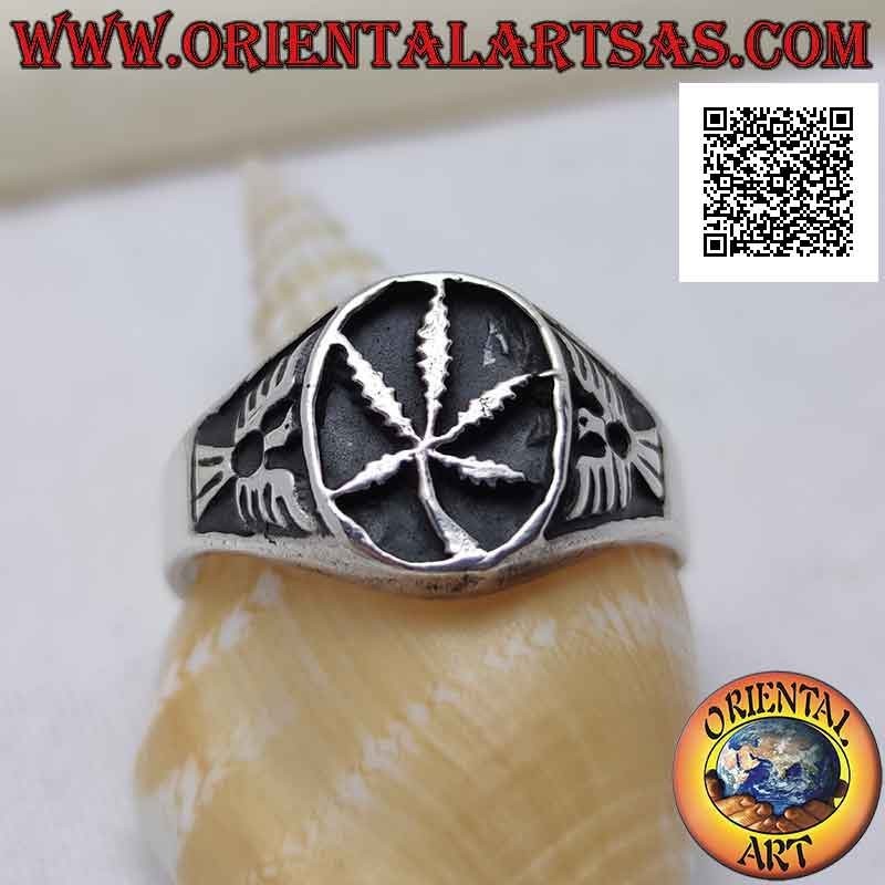Silver ring with marijuana leaf in the oval in bas-relief and eagle on the sides