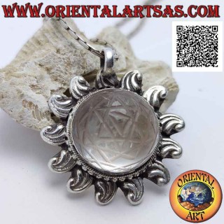 Silver pendant in the shape of a sun shaped with Sri Yantra engraved on central cabochon round rock crystal