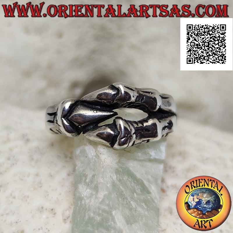 Silver ring in the shape of three dragon claws enveloping in a strong grip