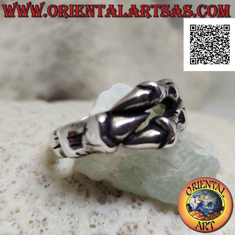 Silver ring in the shape of three dragon claws enveloping in a strong grip