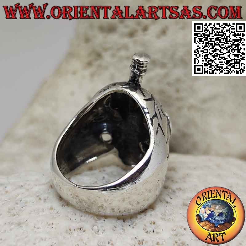 Silver ring in the shape of a suffering skull with a sword stuck in the skull