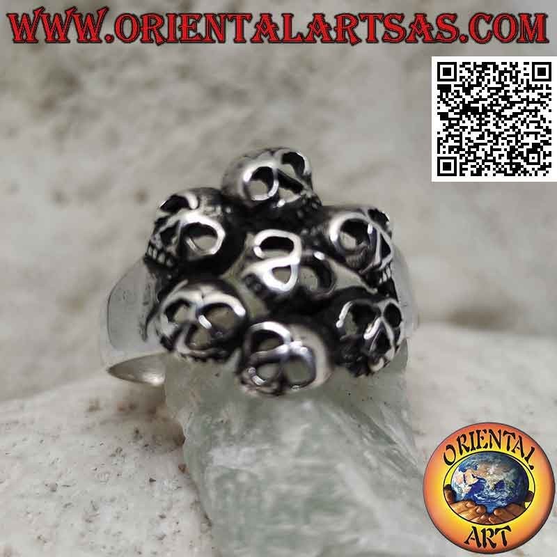 Silver ring with circle of seven perforated skulls