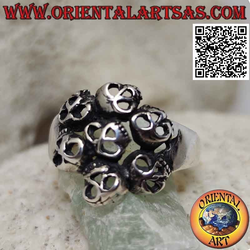 Silver ring with circle of seven perforated skulls