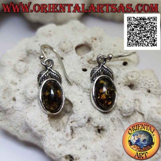 Silver pendant earrings with oval green amber surrounded by a smooth edge and a pair of leaves above