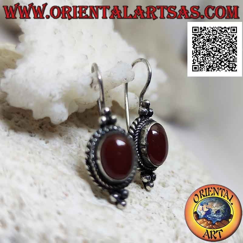 Silver earrings with cabochon oval carnelian surrounded by interweaving and trio of balls above and below
