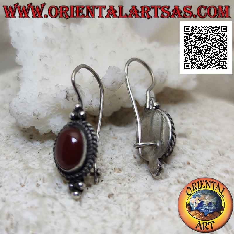 Silver earrings with cabochon oval carnelian surrounded by interweaving and trio of balls above and below