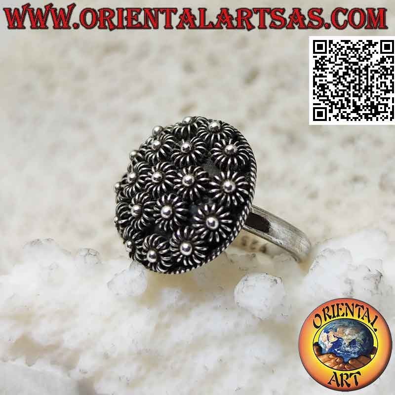 Silver ring with round dome of bas-relief flowers