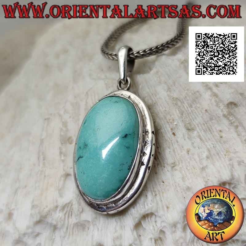 Silver pendant with oval antique turquoise and smooth protruding edge engraved on the cardinal points