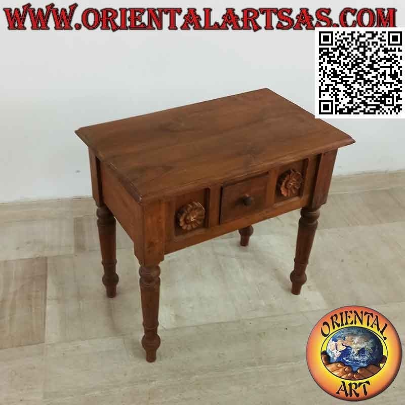 Ethnic coffee table with drawer among sunflowers in relief in teak wood