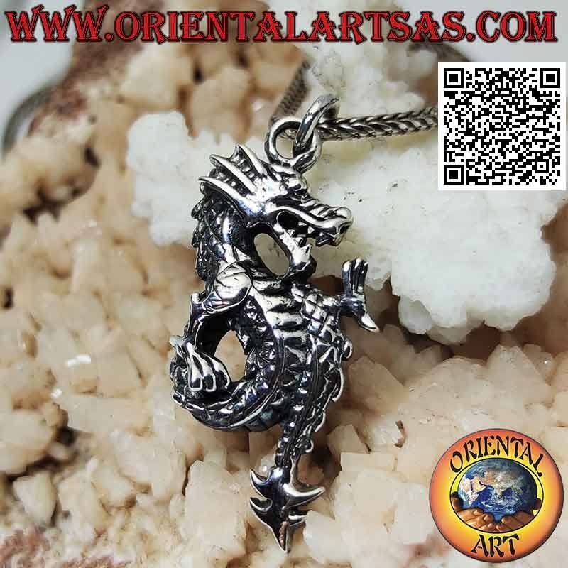 Silver pendant in the shape of a lindworm dragon in profile with a coiled tail