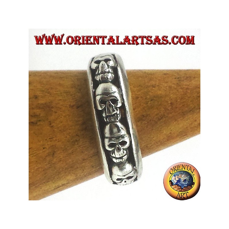 925 sterling silver band ring featuring a row of high relief skulls and an oxidized finish.