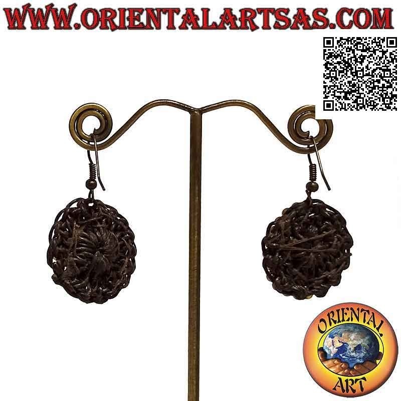 Handmade earrings in macramé technique with oval turquoise paste surrounded by golden brass balls