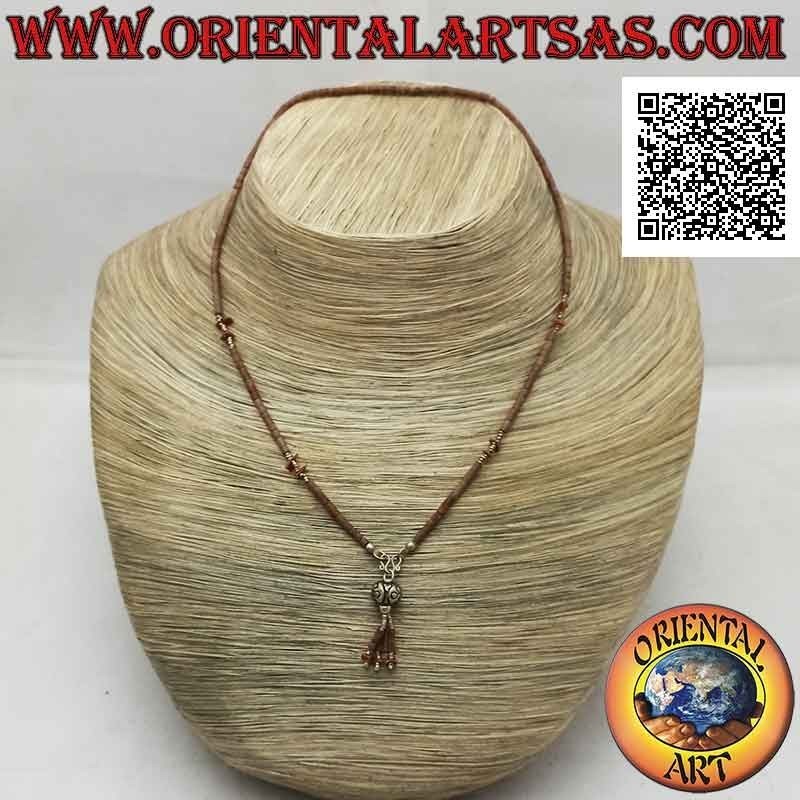 Choker necklace of tubes and fragments of raw brown jade and 925 ‰ silver strung with a tuft