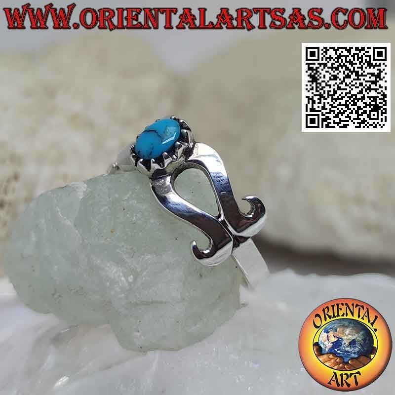 Silver ring with turquoise set in the center of a smooth infinity