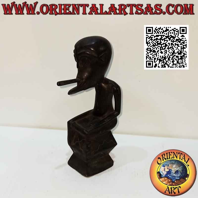 Sculpture of a seated indigenous smoker in ebony wood