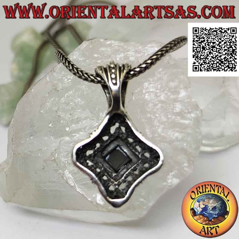 Silver pendant with rhomboidal onyx surrounded by Greek frets on perforated and rounded frame with hollow sides