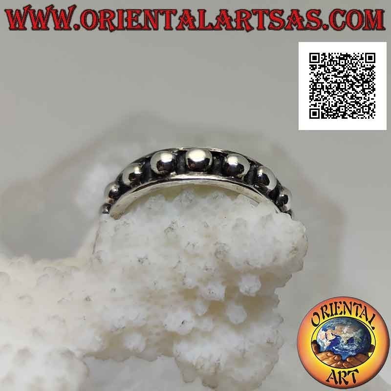Silver band ring with large smooth spheres on a bas-relief background