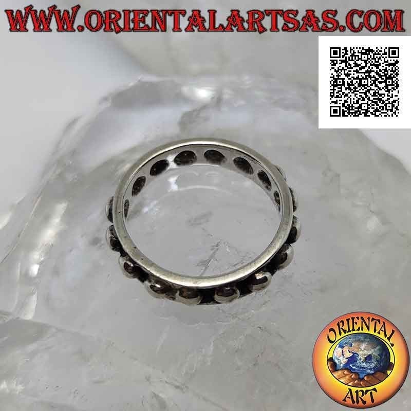 Silver band ring with large smooth spheres on a bas-relief background