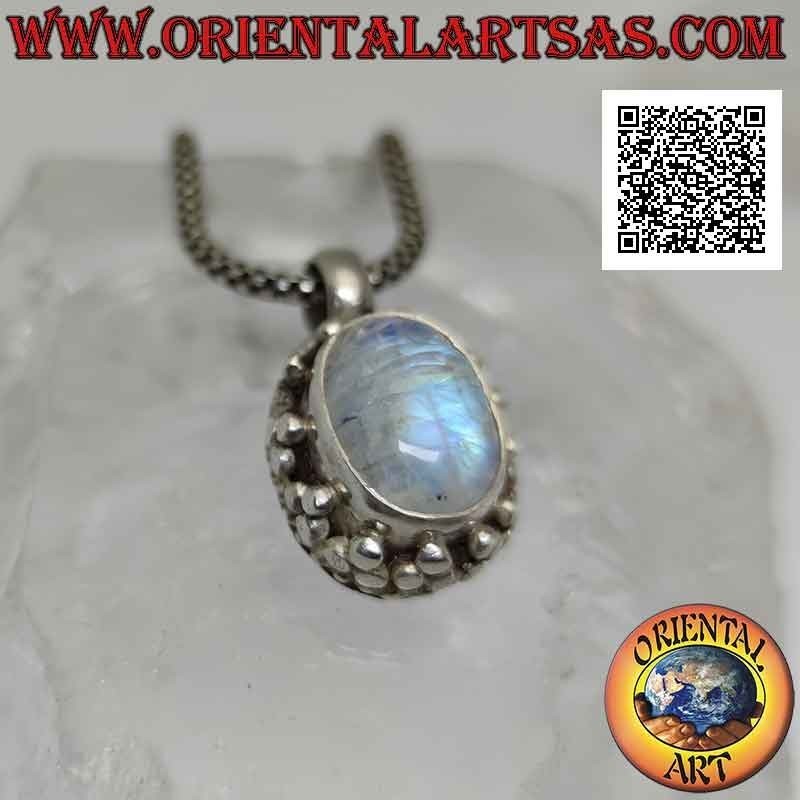 Silver pendant with cabochon oval moonstone surrounded by a double row of balls and tris