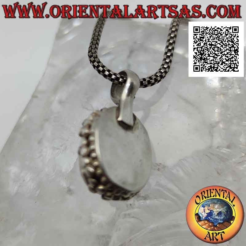 Silver pendant with cabochon oval moonstone surrounded by a double row of balls and tris