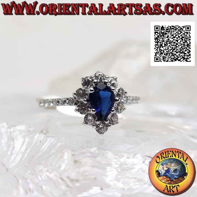 Silver ring with synthetic teardrop sapphire surrounded by round white zircons and on the sides